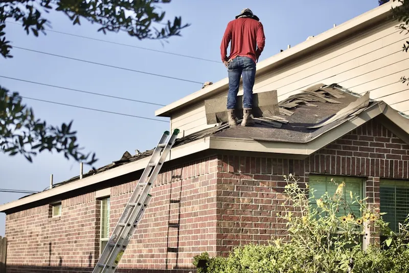 Professional roofer working on a residential roof in Tell City